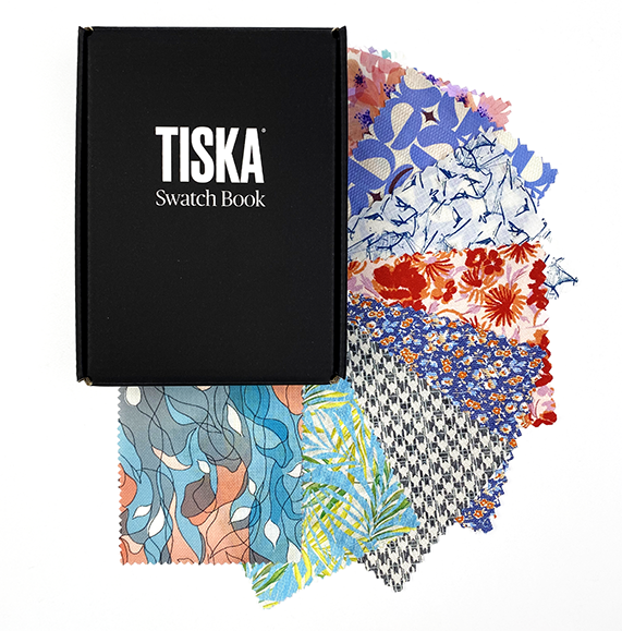 TISKA swatch book with fanned-out fabric swatches in florals and prints